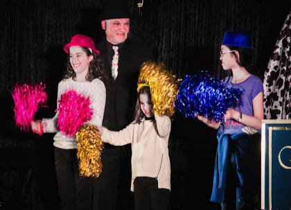 Stage Magic show with audience participation and children on stage 