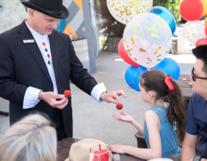 George Stas entertaining a family audience with close up magic